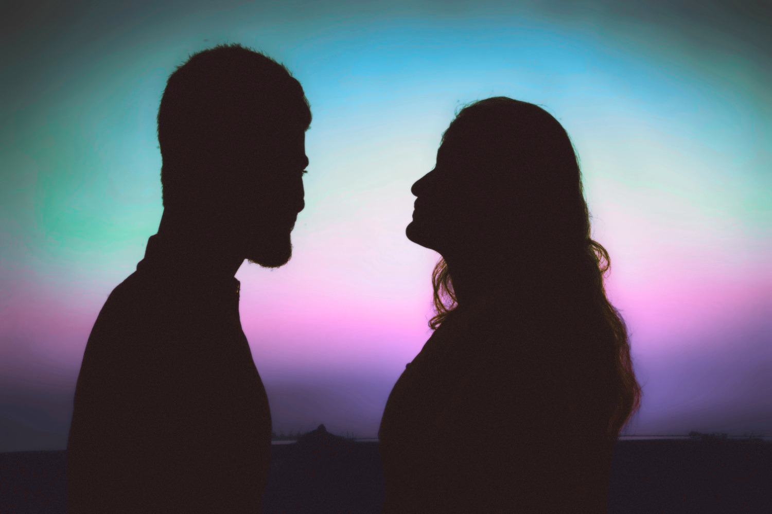 A couple close together at sunset